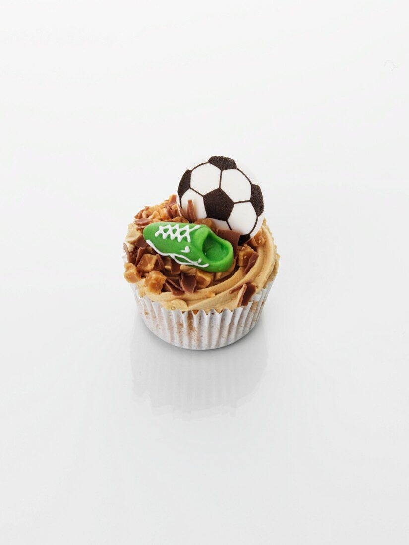 A caramel cupcake decorated with football motifs