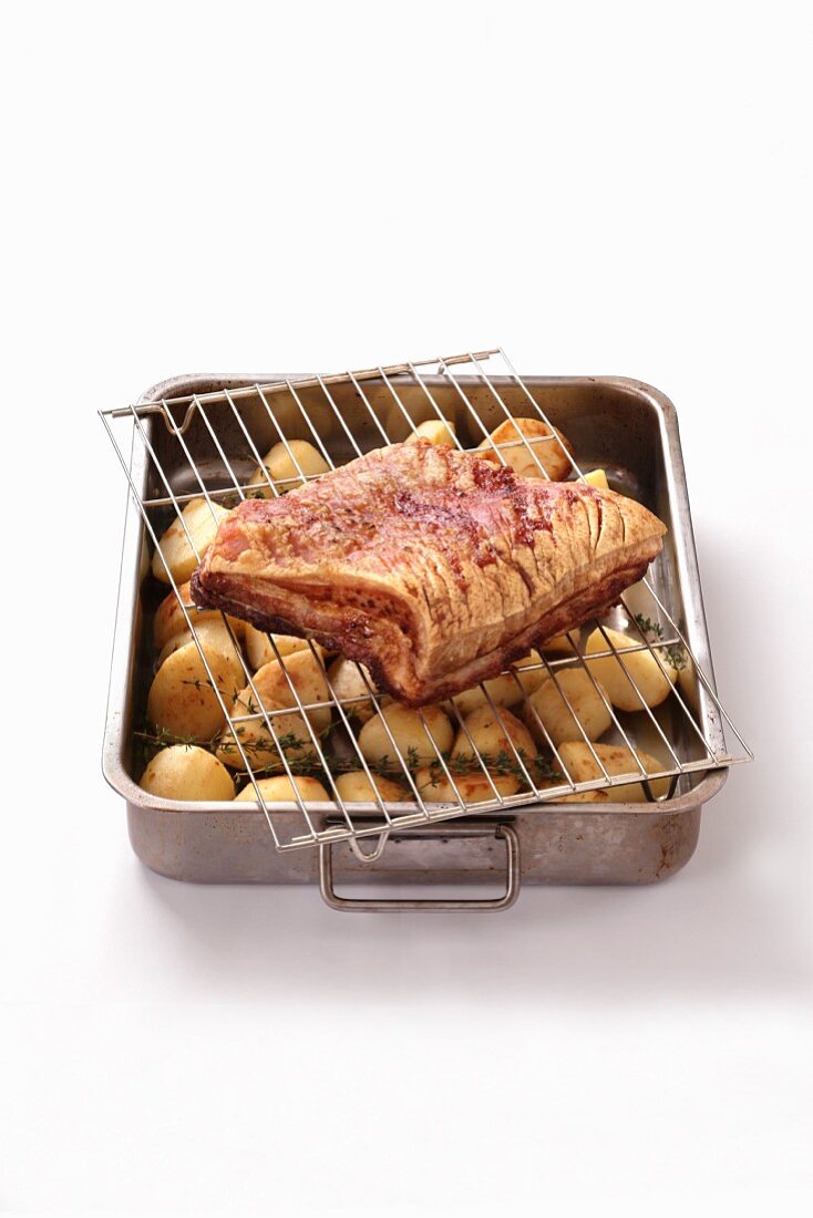 Pork belly on roast potatoes