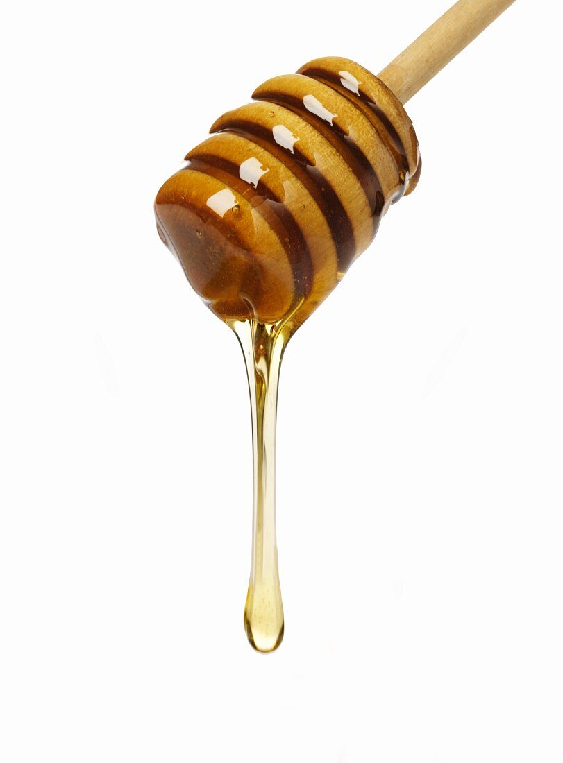 Honey dripping from a honey dipper