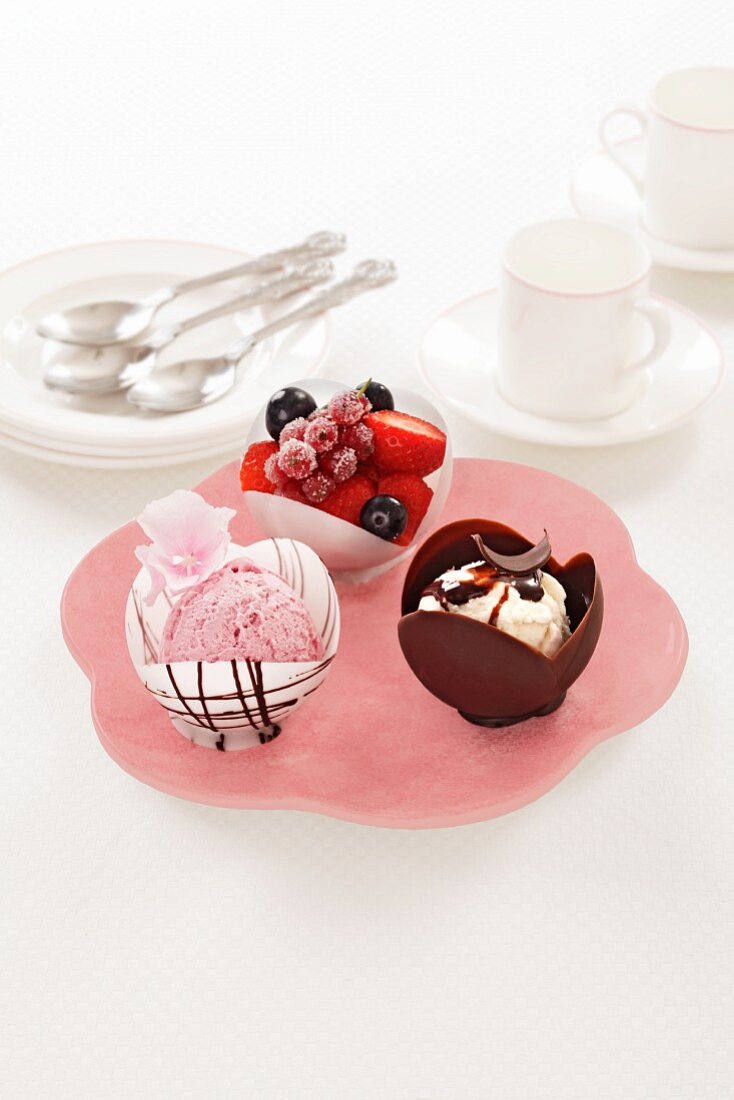 A trio of desserts with ice cream, chocolate and berries