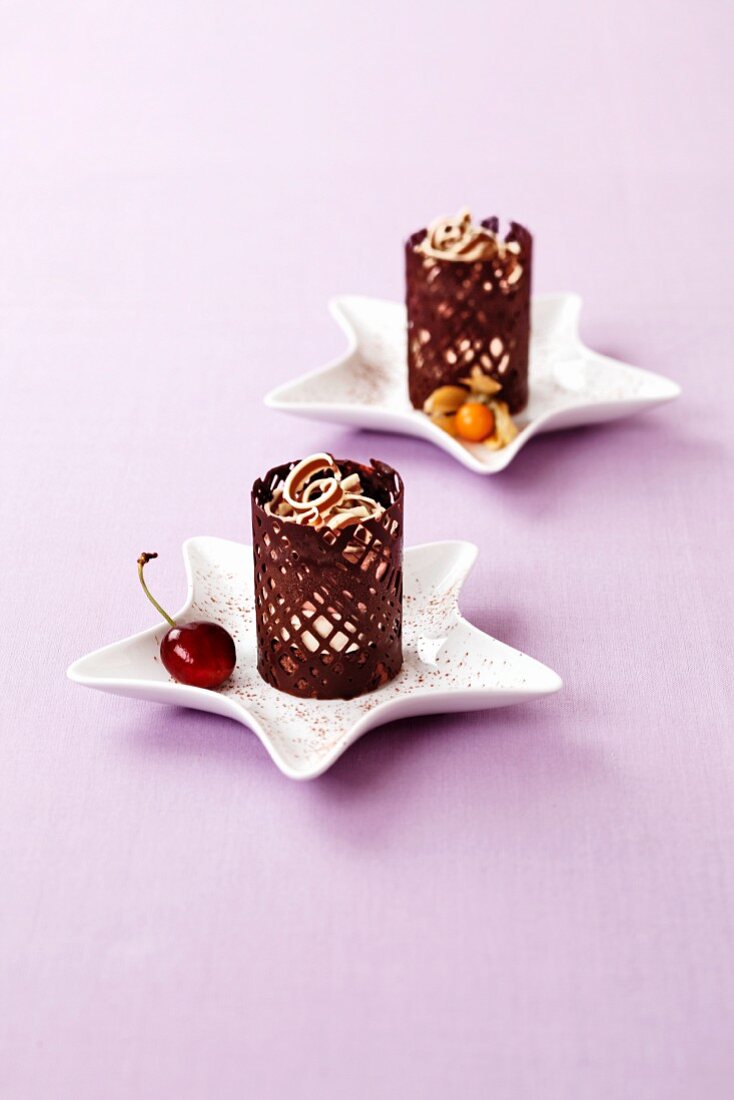 A layered dessert in a chocolate cage