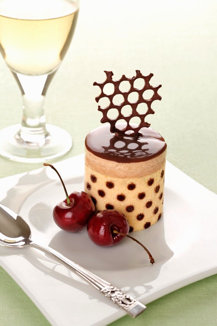 Berry and chocolate mousse cake with cherries