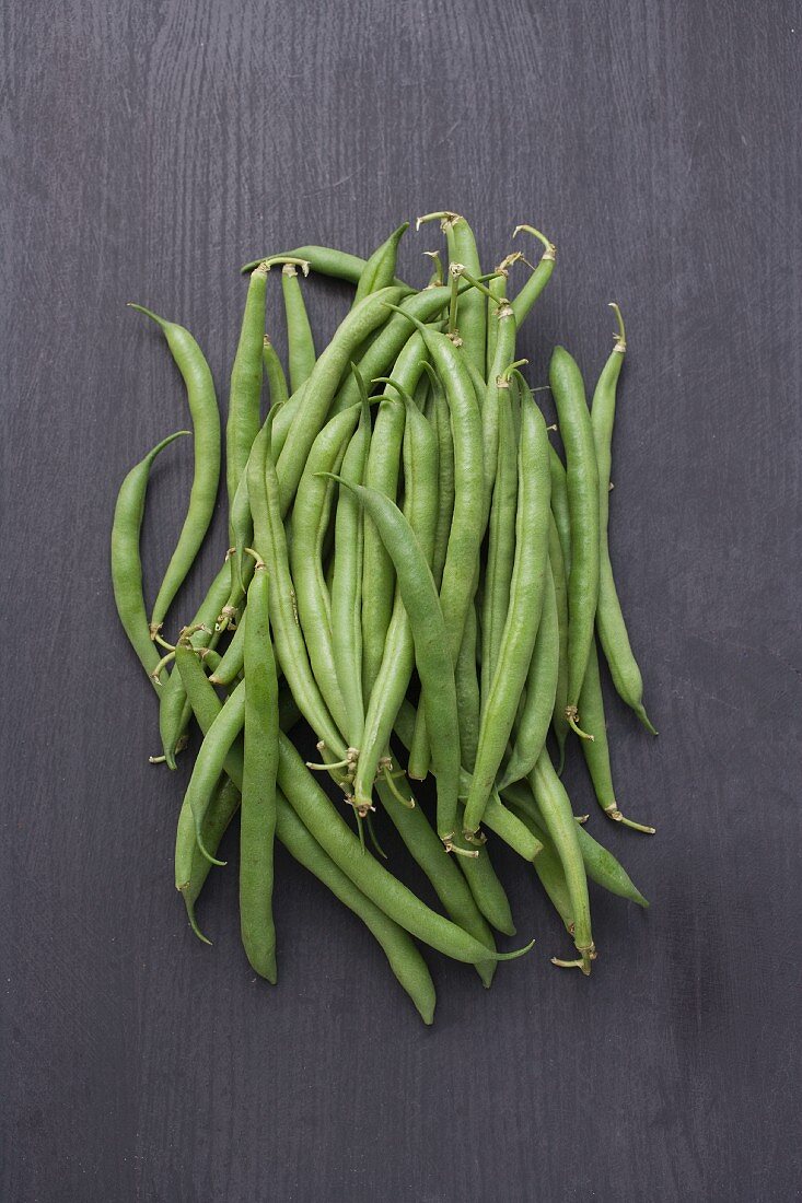 Green beans on a wooden background