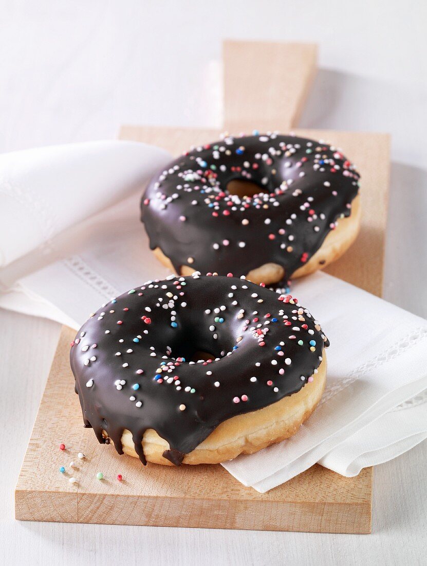 Doughnuts with chocolate glaze and colourful sugar sprinkles