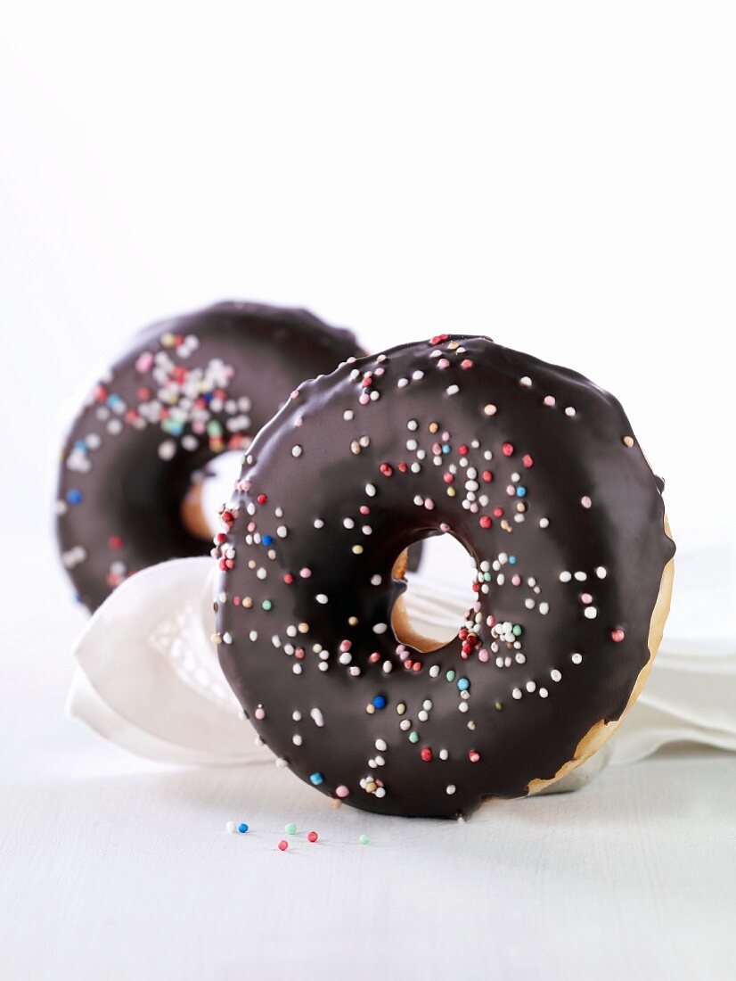 Doughnuts with chocolate glaze and colourful sugar sprinkles
