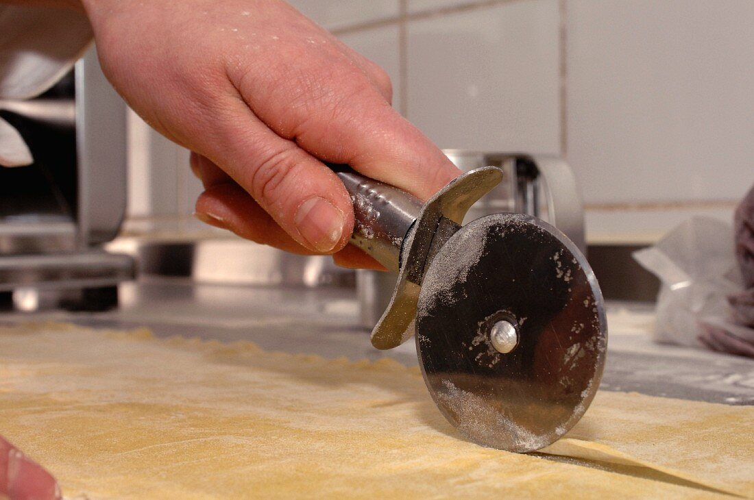 Pastry being cut with a pastry wheel