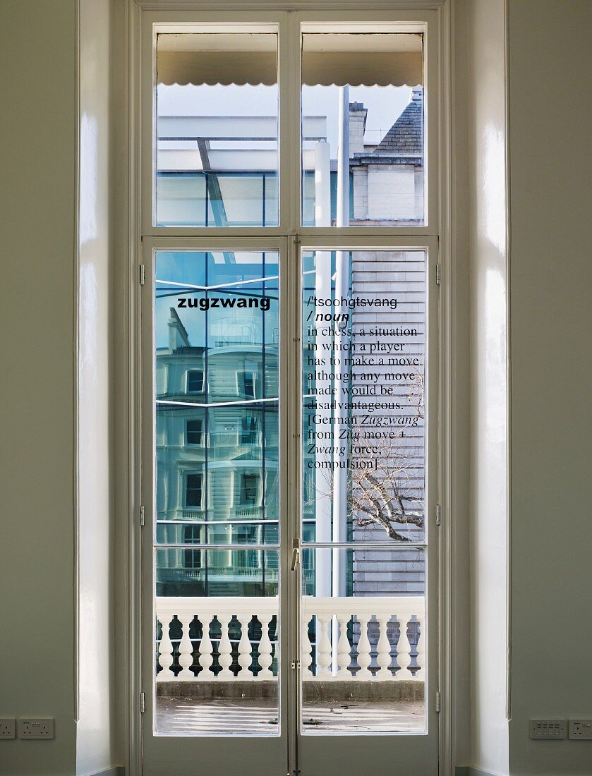 View through closed balcony doors of the modern house next door (Goethe Institut, London)