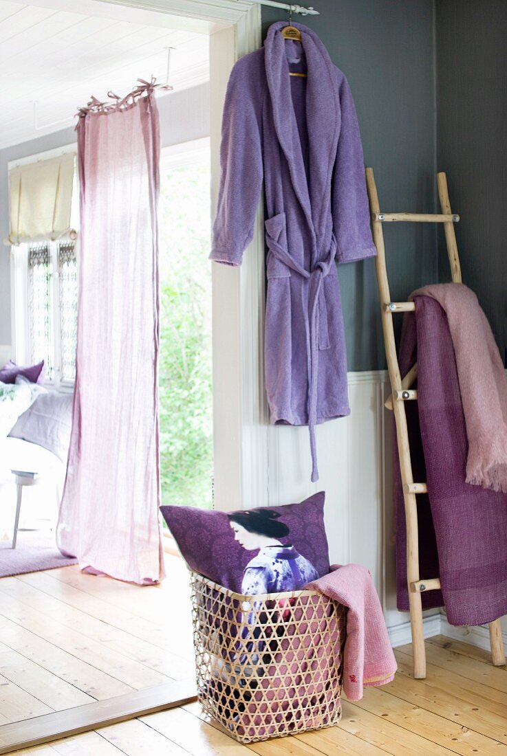 Open garden door with fluttering curtain in sunny room with lilac and violet accents
