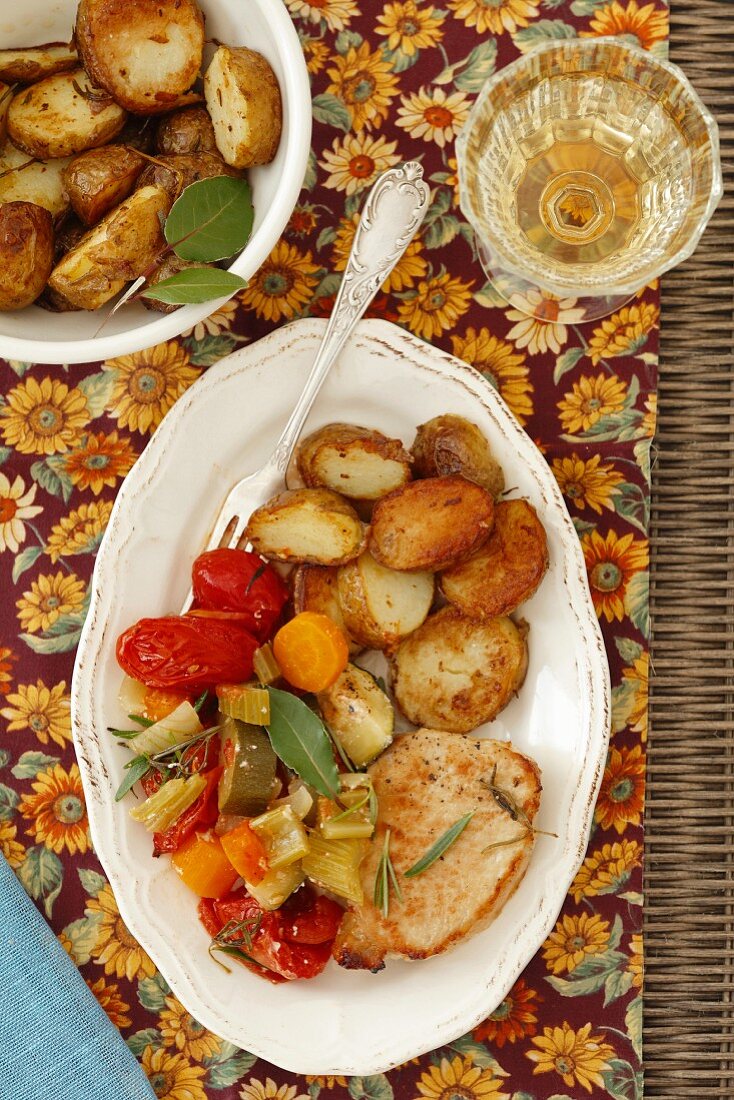 Pork escalope with oven-roasted vegetables and roasted potatoes
