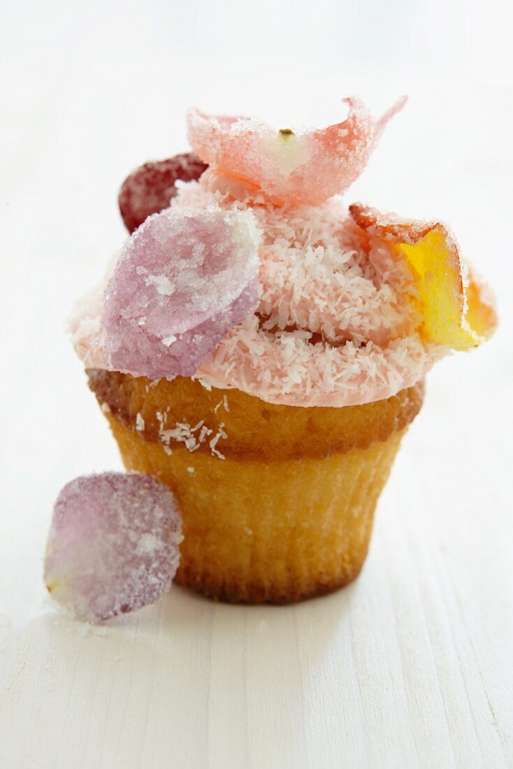 Cupcake with rose petals and grated coconut