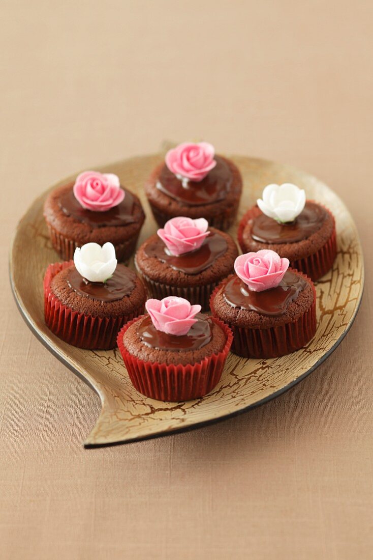 Chocolate muffins decorated with sugar flowers