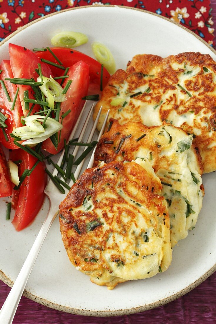 Ricotta cakes with chives and a tomato salad