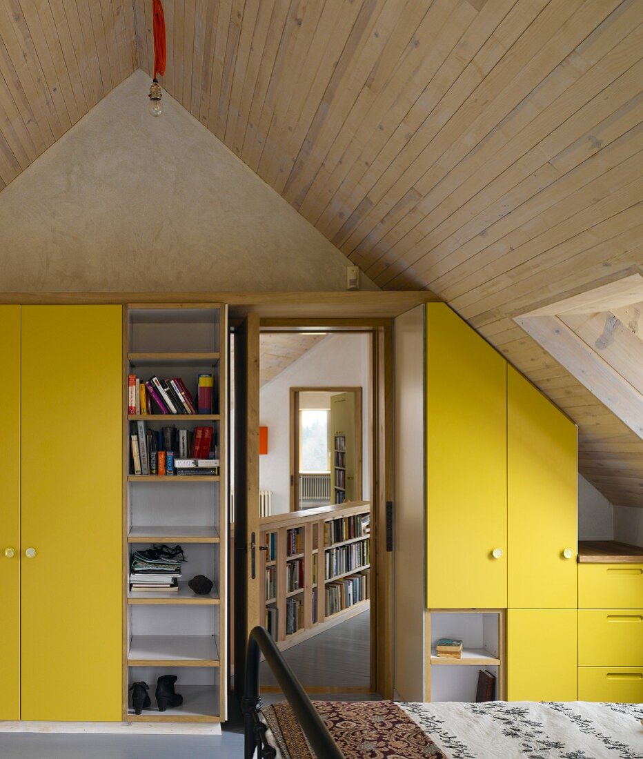 Contemporary, attic bedroom with a wood ceiling and yellow closets (Four Oaks Brick House in the Country)