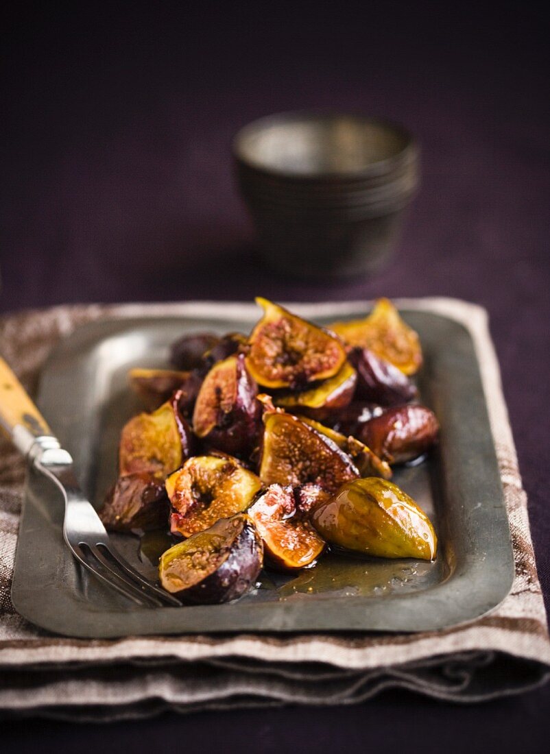 Sauteed Figs on a Metal Tray with a Serving Fork