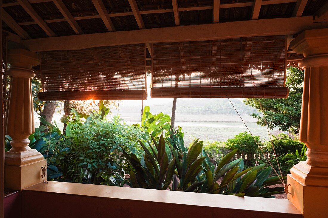 Veranda with colonial-style columns and view of tropical garden