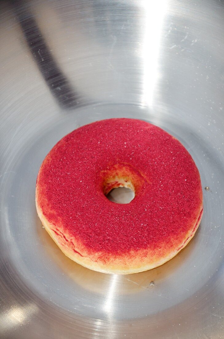 A doughnut dusted with cassis poweder