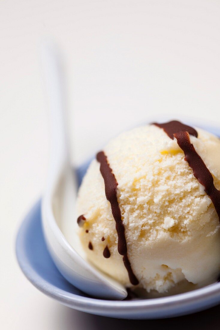 A scoop of homemade ice cream with chocolate sauce