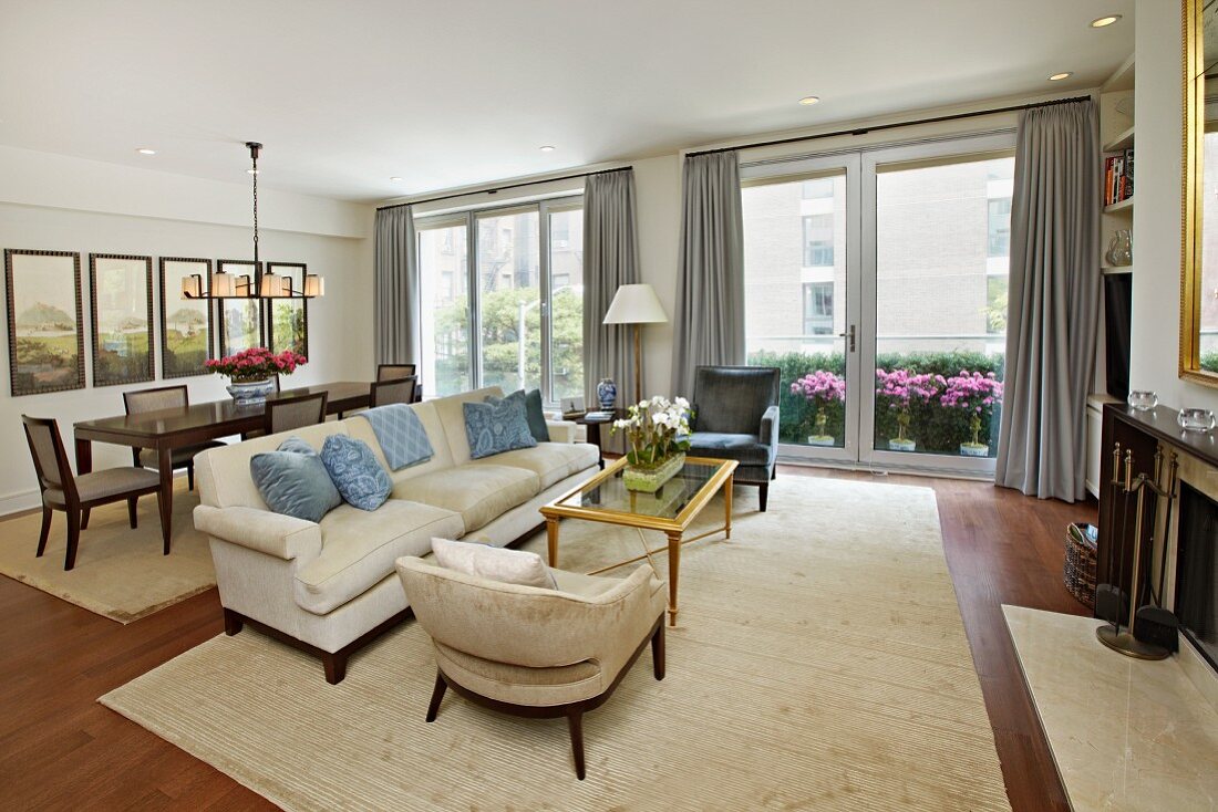 Living Room and Dining Room with a Wall of Windows Looking onto Patio