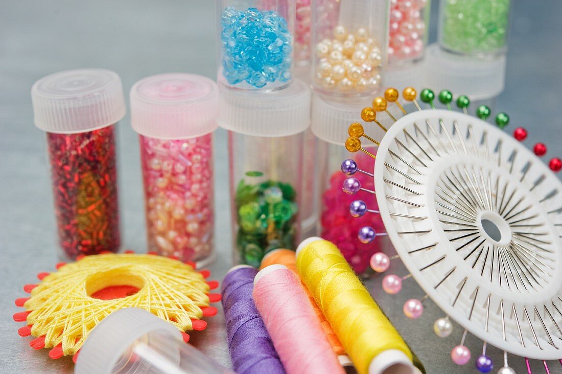 Sewing pins, thread and decorative beads