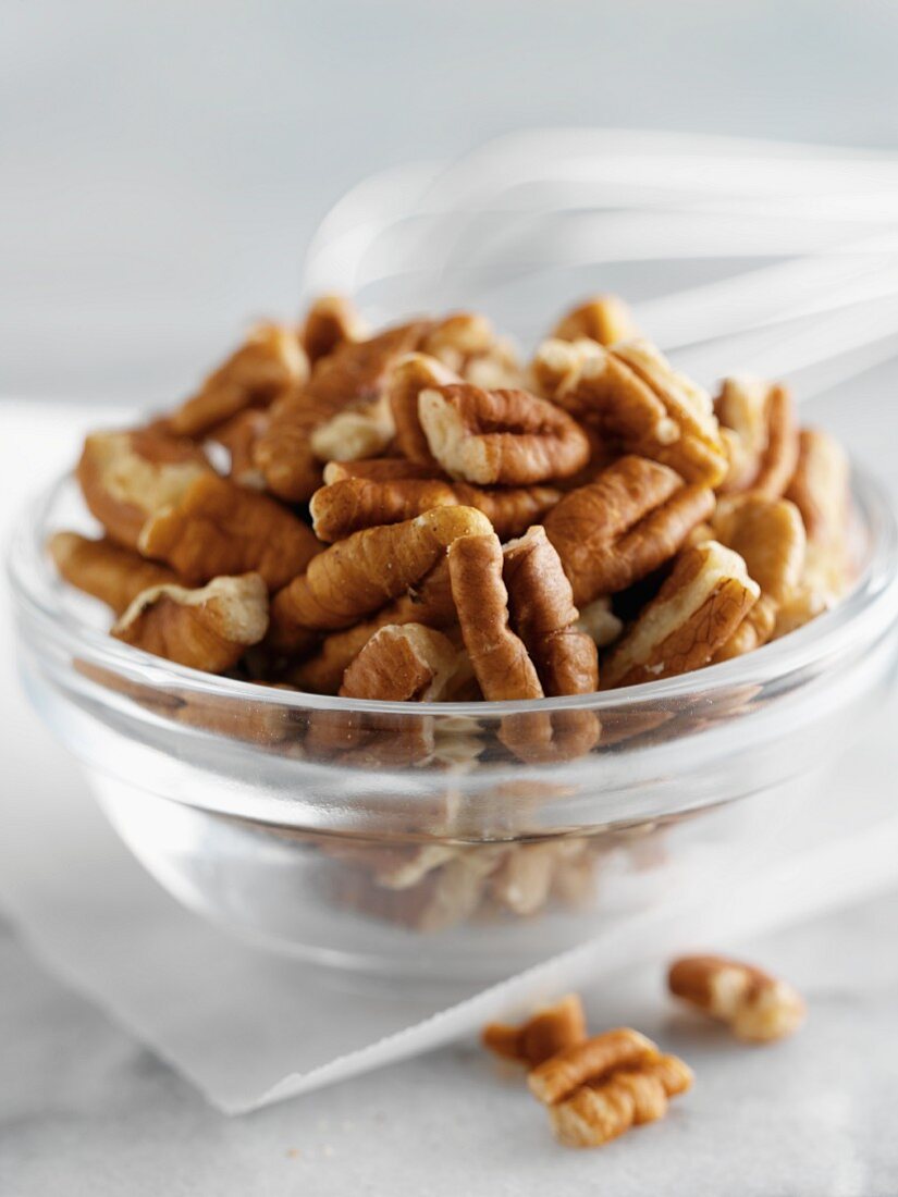 Shelled pecan nuts in a glass bowl
