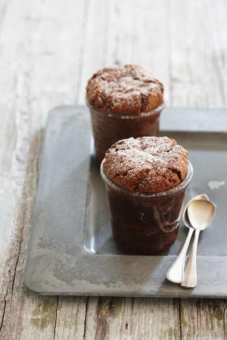 Mini cakes in glasses dusted with icing sugar
