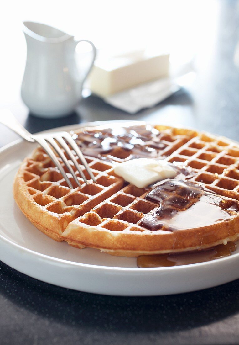 Buttermilk Waffle with Butter and Maple Syrup; Fork