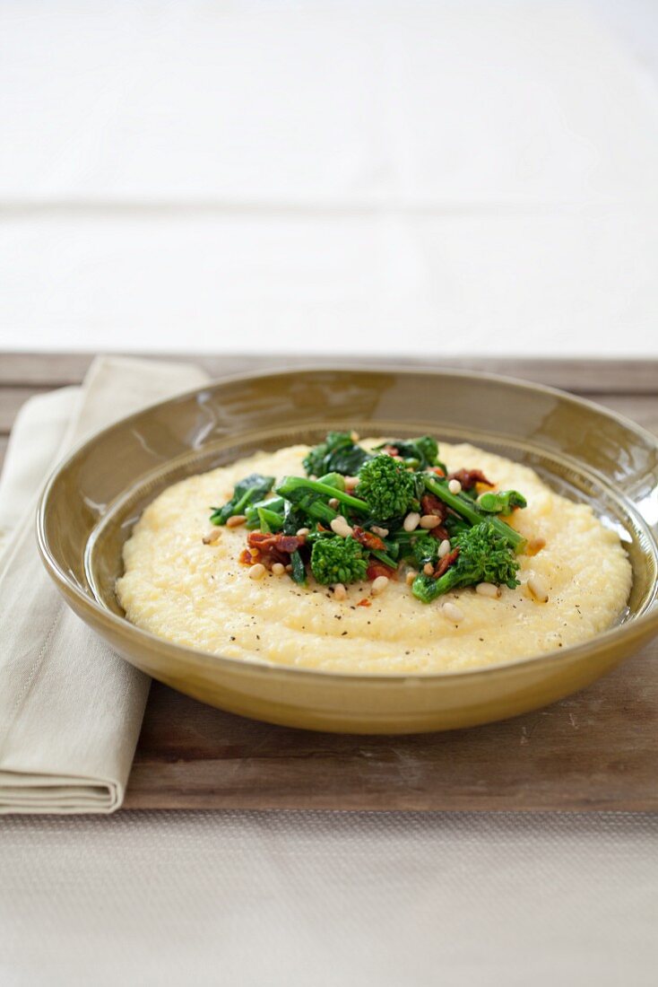 Bowl of Polenta Topped with Broccoli Rabe and Pine Nuts