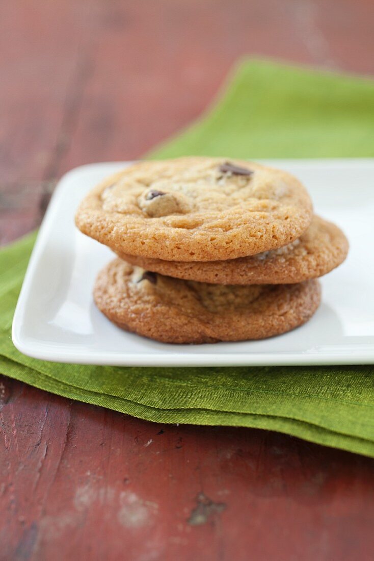 Three Chocolate Chip Cookies Stacked on a Plate
