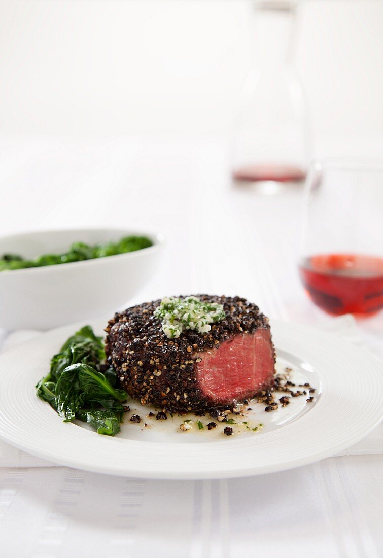 Pepper Crusted Filet Mignon with Wilted Greens