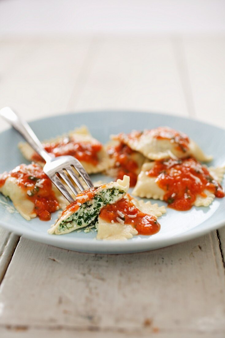 Homemade Spinach Raviolis with Tomato Sauce and a Fork