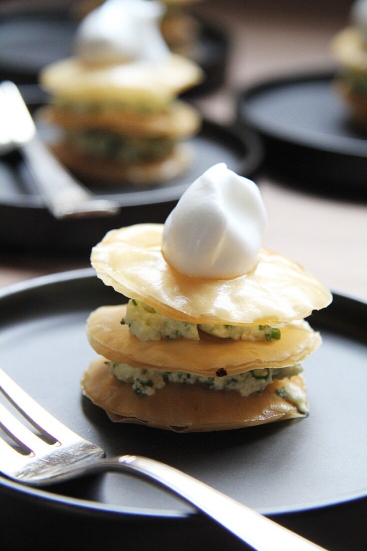 Puff pastry towers with herb sauce