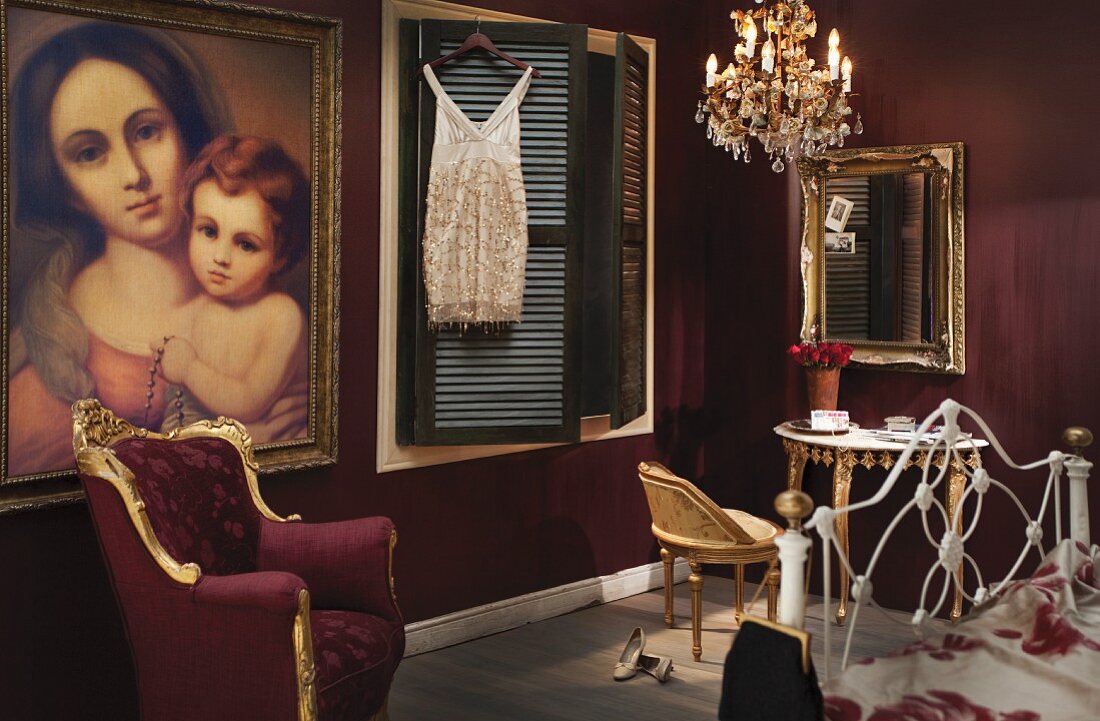 Bedroom with Baroque period furniture, chandelier and large Madonna oil painting on dark red wall