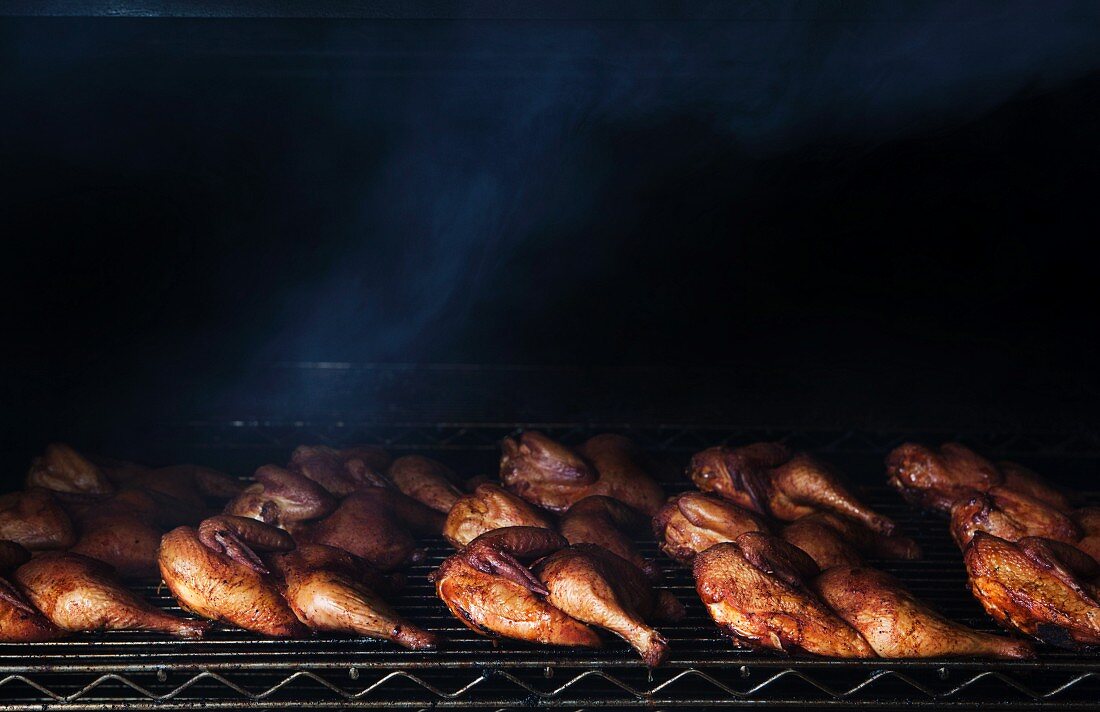 Half Chickens Cooking in a Smoker