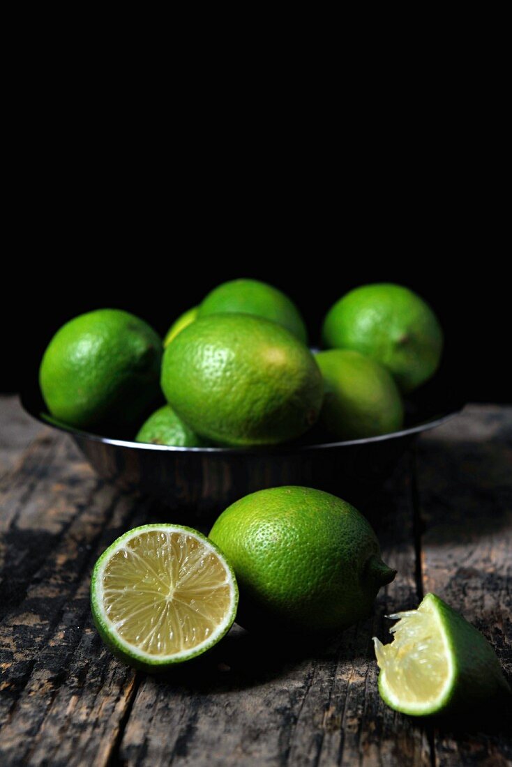 A bowl of limes, whole and halved