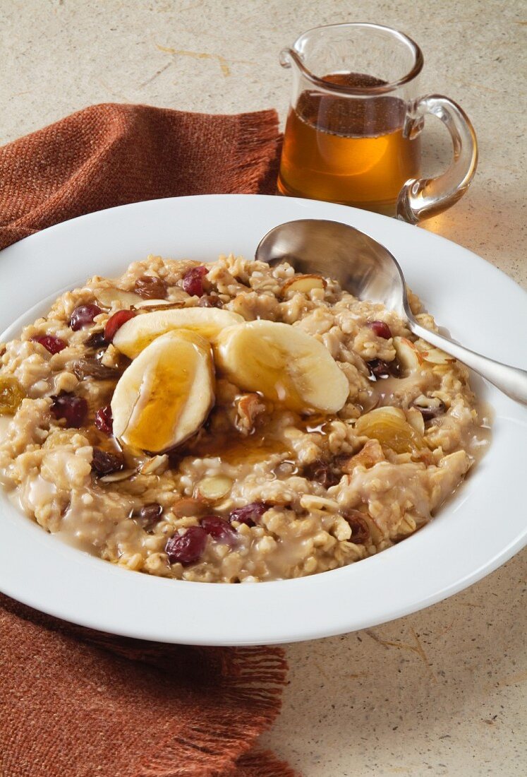 Bowl of Oatmeal with Cranberries, Raisins, Bananas and Nuts