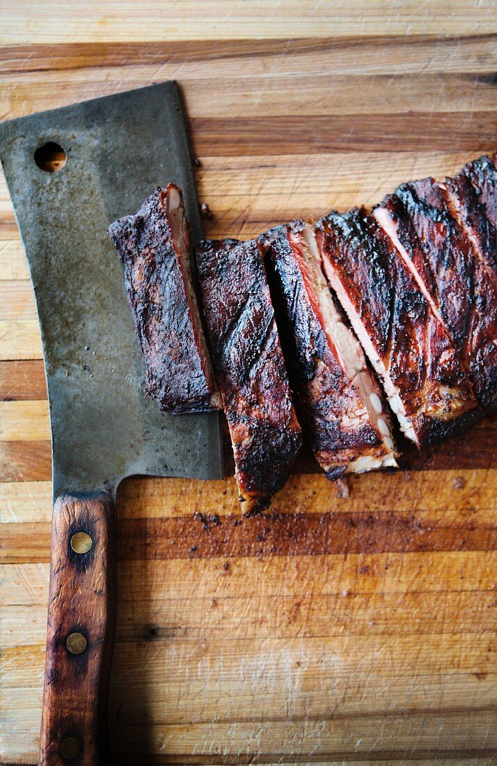 Barbecue Ribs on a Cutting Board with Rustic Knife