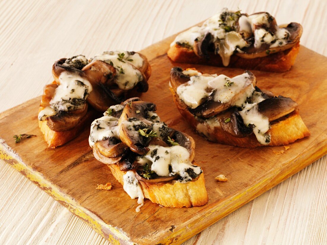 Bruschetta topped with mushrooms and cheese