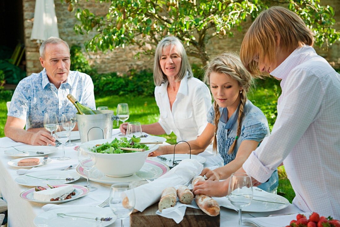 Family eating lunch outdoors