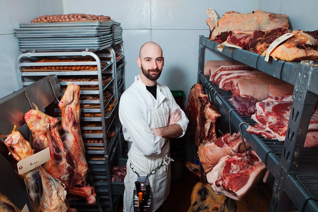 Butcher in meat storage area