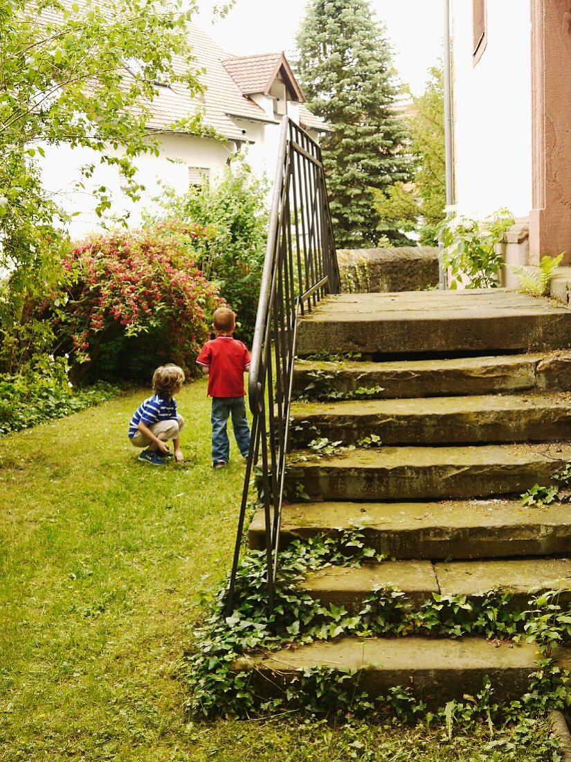 Old stone steps in the garden, children playing next to it