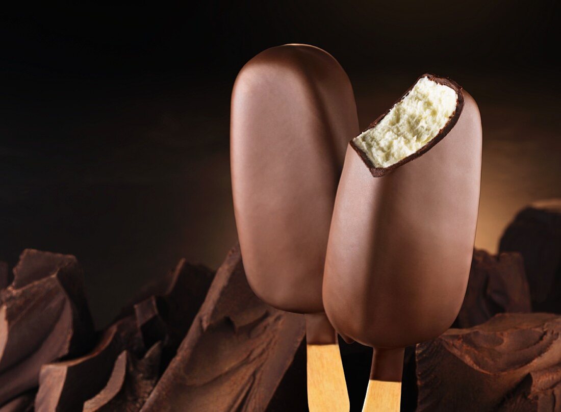 Chocolate-covered vanilla ice cream sticks and pieces of chocolate