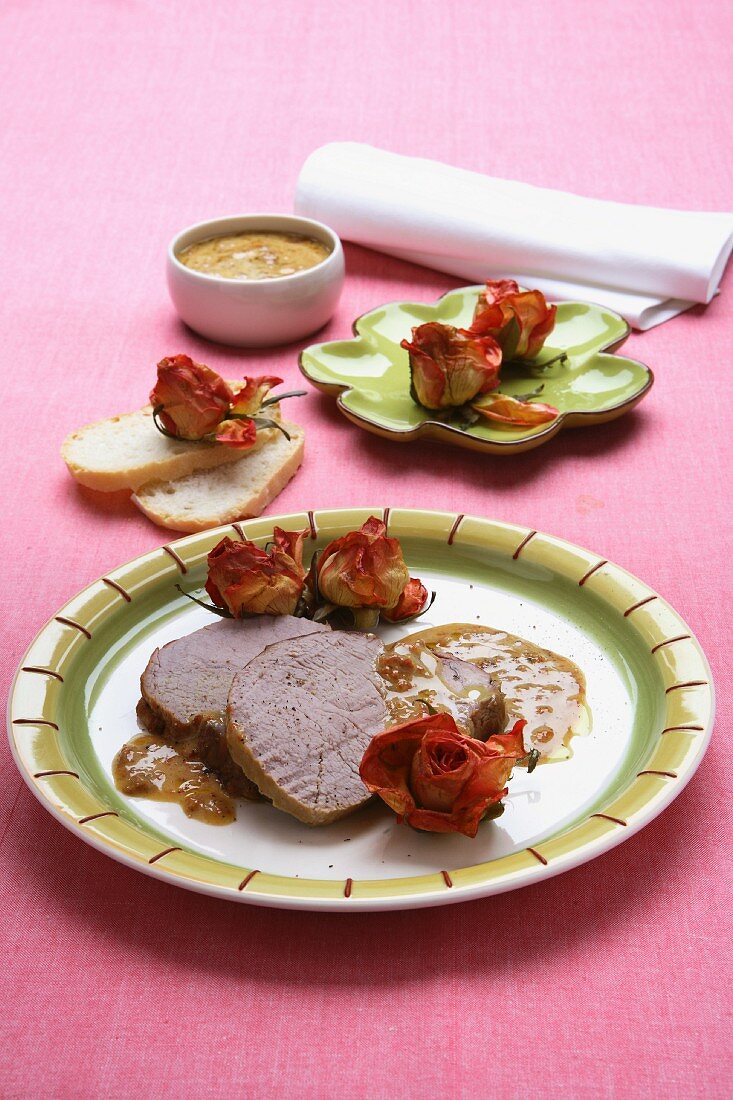 Roast veal with a mustard sauce and rose buds
