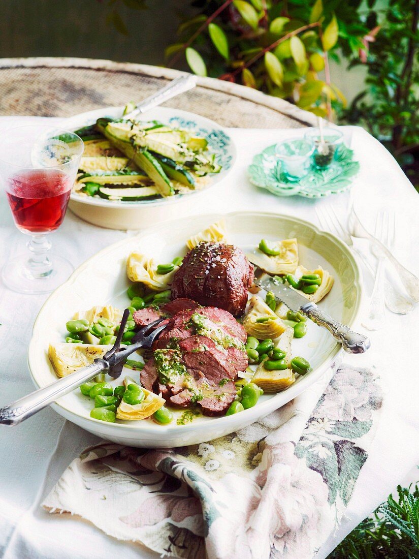 Roasted mini joint of lamb with artichokes and beans