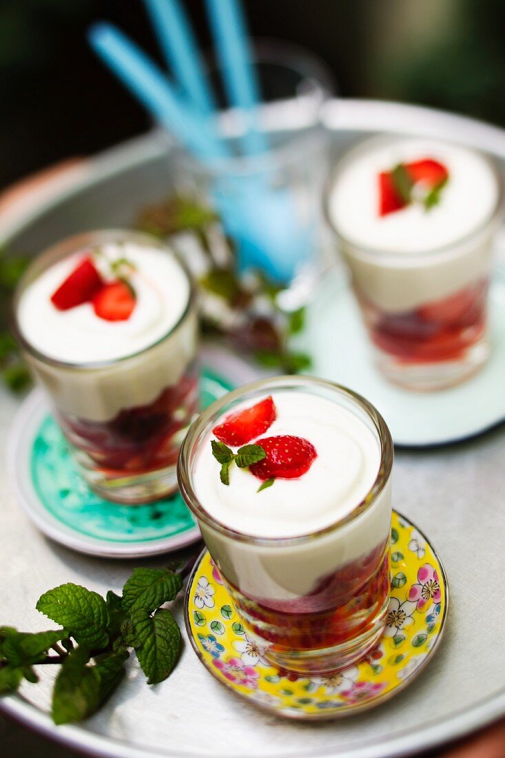 Strawberry desserts in glasses on a table outside