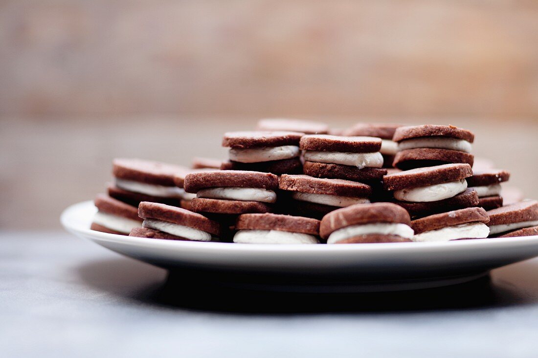 Cream-filled chocolate cookies on a plate