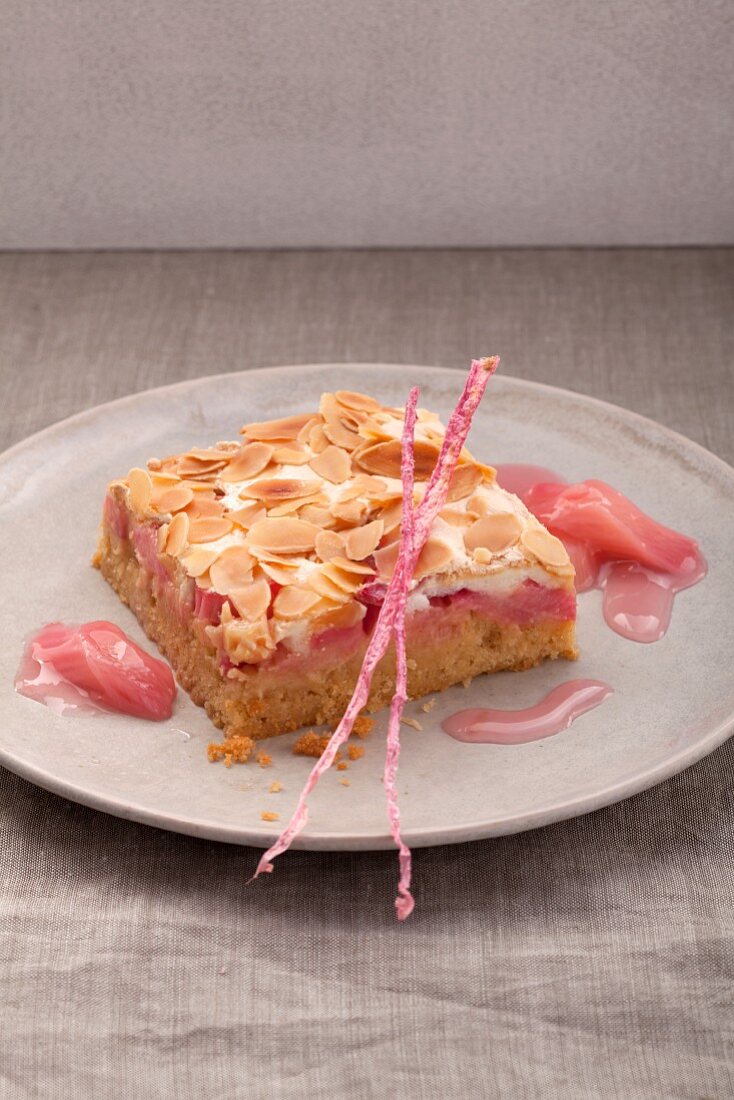 A piece of rhubarb cake with sliced almonds