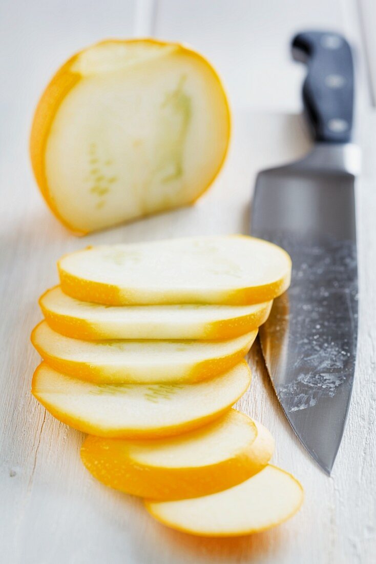 Sliced, round yellow courgette