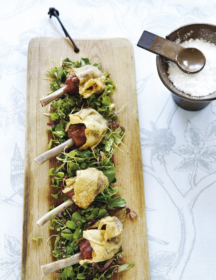 Crispy duck legs on a salad of sprouts