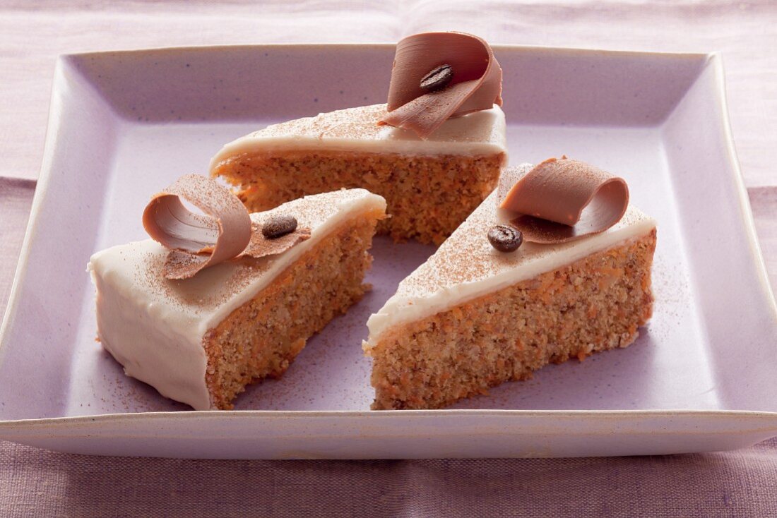 Carrot cake with mocha glaze on a purple plate