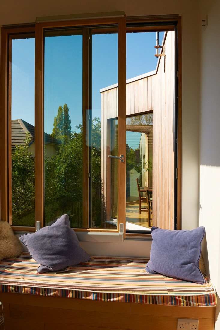 Loggia with scatter cushions on upholstered bench